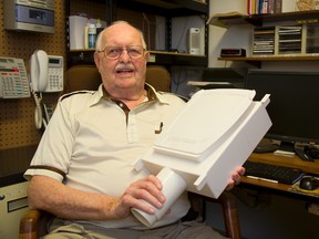 Norman Brooks shows how the self-flush urinal he invented easily fits between the studs in a standard home. (Mike Hensen/The London Free Press)