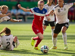 USA Rose Lavelle (5) moves the ball in traffic as Germany players close in during the second half of FIFA U-20 World Cup play at Commonwealth Stadium in Edmonton Alta., on Aug. 5, 2014. Ian Kucerak/Edmonton Sun/ QMI Agency