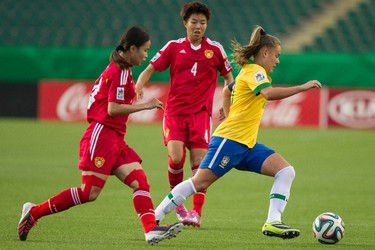 Brazil's Andressa Cavalari Machry (right) is chased by Chinese players during FIFA U-20 Women's World Cup play at Commonwealth Stadium in Edmonton Alta., on Aug. 5, 2014. Ian Kucerak/Edmonton Sun/ QMI Agency