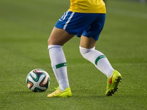 A Brazil player moves the ball across the artificial turf against China during the second half of FIFA U-20 Women's World Cup play at Commonwealth Stadium in Edmonton Alta., on Aug. 5, 2014. Ian Kucerak/Edmonton Sun/ QMI Agency