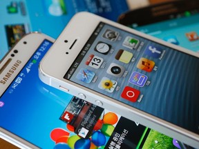 Apple's iPhone 5 (top) and a Samsung Galaxy S4 are seen in this picture illustration taken in Seoul May 13, 2013. REUTERS/Kim Hong-Ji/Files