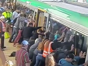 Commuters rescued a man stuck in the gap between the train and the platform in Perth, Australia. (YouTube/Screengrab)