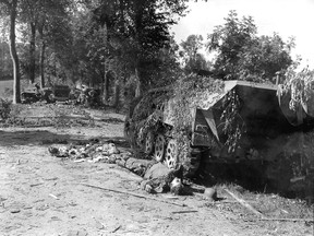 A devastated German tank sits beside a road during the Battle of Mortain, part of Operation Luttich, Aug. 7-13, 1944