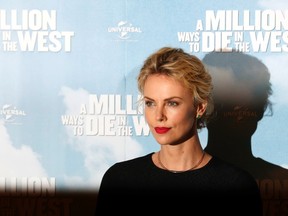 Actress Charlize Theron poses during a photocall for the film "A Million Ways to Die in the West" at Claridge's in London May 27, 2014. (REUTERS/Luke MacGregor)