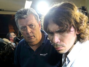 Ray Whelan (L), of Switzerland-based Match Services, arrives at a police station after being arrested in Rio de Janeiro July 7, 2014. REUTERS/Stringer