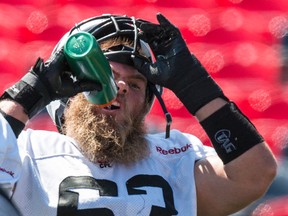 Offensive lineman Jon Gott takes a water break during practice Wednesday at TD Place. (ERROL McGIHON/OTTAWA SUN)