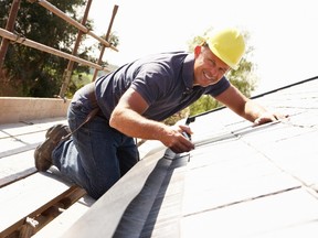 Removing leaves and debris from a roof?s gutters is worthwhile maintenance. (Fotolia)