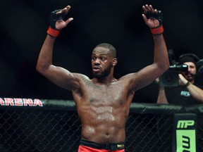 Jon Jones puts his arms in the air after the UFC light heavy weight championship fight against Glover Texeira at  Baltimore Arena. Tommy Gilligan-USA TODAY Sports