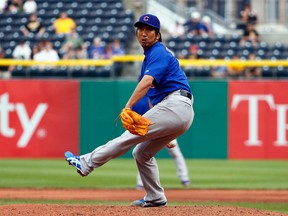 Kyuji Fujikawa #11 of the Chicago Cubs pitches in the eighth inning against the Pittsburgh Pirates. Justin K. Aller/Getty Images/AFP
