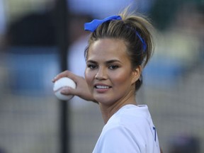 Before the Dodgers-Angels game on August 5, 2014, Chrissy Teigen throws out the first pitch at Dodger Stadium. (WENN)