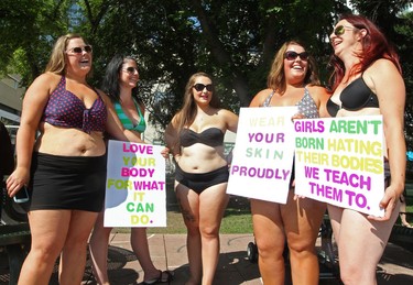 (left to right) Kristin Heimbecker, Amanda Lanctot, Brittany Gammon, Janine Foote, and Carmen Vickery take part in a Bare Your Belly protest in support of Tanis Jex-Blake outside City Hall in Edmonton Alta., on Wednesday Aug. 6, 2014. Jex-Blake says she was recently bullied at a local beach for wearing a bathing suit that revealed her pregnancy stretch marks. David Bloom/Edmonton Sun/QMI Agency