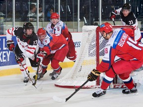 Connor McDavid muscles his way past a couple of Russian defenders during Wednesday's exhibition game in Sherbrooke. (Matthew Murnaghan/Hockey Canada)