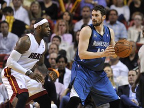 Minnesota Timberwolves forward Kevin Love (42) is pressured by Miami Heat forward LeBron James (6) during the second half at American Airlines Arena. The Minnesota Timberwolves won in 2 overtimes 122-121. Mandatory Credit: Steve Mitchell-USA TODAY Sports
