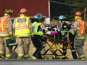 First responders transport an injured person from the scene of a serious three-vehicle crash south of Stratford. (Postmedia Network file photo)