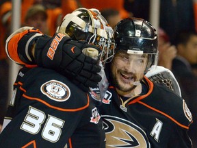 Anaheim Ducks goalie John Gibson (36) is embraced by right wing Teemu Selanne (8) after game five of the second round of the 2014 Stanley Cup Playoffs against the Los Angeles Kings at Honda Center.  (Kirby Lee-USA TODAY Sports)