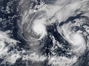 Hurricane Iselle and Hurricane Julio (R) are pictured en route to Hawaii in this August 5, 2014 NASA handout satellite image. Hurricane Iselle is expected to make landfall on Hawaii August 7, 2014.  REUTERS/NASA/Handout via Reuters