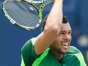 Jo-Wilfred Tsonga defeats Novak Djokovic in straight sets at Rogers Cup in Toronto on Thursday, August 7, 2014. (Stan Behal/Toronto Sun)
