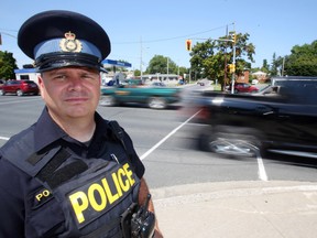Quinte West OPP Const. Dave Ludington stands at the busy intersection of Dundas Street East and Byron Street Wednesday, August 6, 2014 in Trenton, Ont. Concerned by a rise in certain collisions, police are planning more public education and enforcement. Luke Hendry/Belleville Intelligencer/QMI Agency