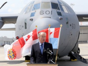 Minister of National Defence Robert Nicholson speaks about Canadian support for Ukraine at 8 Wing Trenton, Thursday, Aug. 7, 2014. Behind is the C130 J Hercules carrying the first shipment of non-lethal military equipment. the Canadian Forces are sending to Ukraine. 
EMILY MOUNTNEY-LESSARD/THE INTELLIGENCER/QMI AGENCY