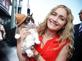 Grumpy Cat arrives with his owner Tabatha Bundesen at the 2014 MTV Movie Awards in Los Angeles, April 13, 2014.  REUTERS/Lucy Nicholson