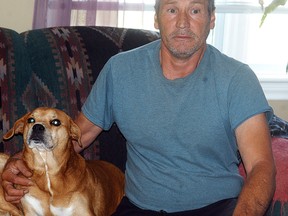 Henry Brown poses with Maggie, one of his three dogs. Brown said he gave up a fourth dog named Ricky to the Wallaceburg Animal Shelter earlier this month, but immediately regretted the decision. Despite pleas to return Ricky, Brown says the Animal Shelter refused and adopted the dog to another family. DAVID GOUGH/COURIER PRESS/QMI AGENCY