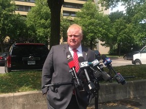 Mayor Rob Ford speaks to reporters after touring an apartment building at 470 Sentinal Rd. on Friday, Aug. 8, 2014. (DON PEAT/Toronto Sun)