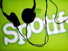 Headsets hang in front of a screen displaying a Spotify logo on it, in Zenica Feb. 20, 2014.  REUTERS/Dado Ruvic