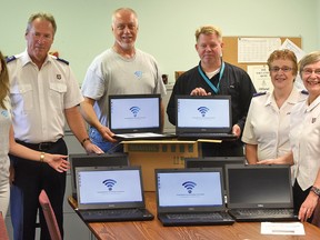 CHRIS ABBOTT/TILLSONBURG NEWS
Representatives from Siemens Canada and Corporations for Community Connections Inc. donated 98 refurbished laptop computers to The Salvation Army Tillsonburg Wednesday morning. The computers will be distributed in the community through an application process. From left are Kate Milner (Siemens Canada communications and strategy department), Salvation Army pastor Ron Ferris, Phlip Schaus (president of Corporations for Community Connections Inc. and purchasing agent for Siemens Canada), Niels Kelter (Siemens plant manager in Tillsonburg), and Salvation Army's Donna Acre, community ministries coordinator and pastor Starr Ferris.