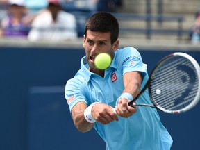 Novak Djokovic (SRB) lines up a forehand against Jo-Willfried Tsonga (FRA)  on day four of the Rogers Cup tennis tournament at Rexall Centre. Tsonga won 6-2 6-2 on Aug 7, 2014 in Toronto, Ontario, Canada. (Peter Llewellyn/USA TODAY Sports)