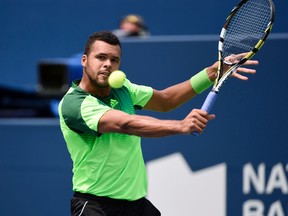 Jo-Wilfried Tsonga (FRA) plays a backhand against Andy Murray (GBR) on day five of the Rogers Cup tennis tournament at Rexall Centre on Aug 8, 2014 in Toronto, Ontario, Canada. (Peter Llewellyn/USA TODAY Sports)