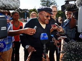 Archbishop Desmond Tutu speaks to the media as he arrives to cast his vote during the South African election in Cape Town May 7, 2014. (REUTERS/Mark Wessels)