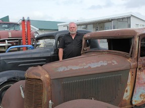 Murray King (Kustom King), who has owned more than 1,500 cars in his lifetime, stands with a 1932 DeSoto and a 1934 Oldsmobile (both three-window coupes) that will be up for auction on Aug. 16 and 17. - Karen Haynes, Reporter/Examiner