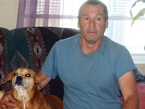 Henry Brown poses with Maggie, one of his three dogs. Brown said he gave up a fourth dog named Ricky to the Wallaceburg Animal Shelter earlier this month, but immediately regretted the decision. Despite pleas to return Ricky, Brown says the Animal Shelter refused and adopted the dog to another family. DAVID GOUGH/COURIER PRESS/QMI AGENCY