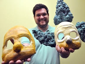 Director Garrett Rodman holds a couple commedia dell'arte-style masks August 7, 2014. They were made specifically for his upcoming production of Mr. Burns, a post-electric play at the McManus Studio Theatre at the end of the month. CHRIS MONTANINI\LONDONER\QMI AGENCY