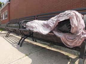 The Homeless Jesus statue has been prompting police calls from concerned citizens worried about someone laying, unmoving on a bench on Mitton Street. BRENT BOLES / THE OBSERVER / QMI AGENCY