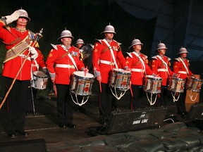 Drum Line opens PPCLI 100th Anniversary Warrant Officer Kennedy (left) of the Princess Patricia’s Canadian Light Infantry (PPCLI) Drum Line salutes almost 2,000 guests who gathered in the Lecture Training Facility at Edmonton Garrison last night to kick off the PPCLI 100th Anniversary.  The public is invited to the Garrison on Aug. 9 to see numerous military displays and demonstrations.  PPCLI photo by Grant Cree.