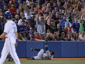 Rajai Davis of the Detroit Tigers makes a sliding catch to end the game in the ninth inning against the Toronto Blue Jays on August 8, 2014 at Rogers Centre. (Tom Szczerbowski/Getty Images/AFP)