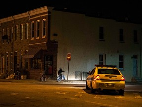 Police patrol a residential neighbourhood in east Baltimore minutes after a curfew law took effect in Baltimore August 8, 2014. REUTERS/James Lawler Duggan