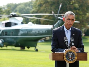 U.S. President Barack Obama pauses as he speaks to the media on the situation in Iraq on the South Lawn of the White House, before his departure for vacation at Martha's Vineyard, in Washington August 9, 2014. REUTERS/Yuri Gripas