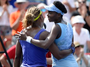 Venus Williams (USA) (right) hugs Serena Williams (USA) (left) after winning their match on day six of the Rogers Cup tennis tournament at Uniprix Stadium on Aug 9, 2014 in Montreal, Quebec, Canada. (Eric Bolte/USA TODAY Sports)