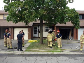 Firefighters knocked out a fire that left two townhouses uninhabitable and claimed the life of a family dog on Foxwell St. Saturday afternoon. Megan Gillis/Ottawa Sun