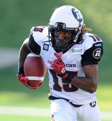 Jamill Smith from the Ottawa Redblacks runs the ball back against the Calgary Stampeders during CFL action in Calgary, Alta. on Saturday August 9, 2014. Stuart Dryden/Calgary Sun/QMI Agency