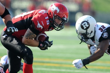 Quarterback Bo Levi Mitchell from the Calgary Stampeders runs it in for the games first touchdown against the Ottawa Redblacks during CFL action in Calgary, Alta. on Saturday August 9, 2014. Stuart Dryden/Calgary Sun/QMI Agency
