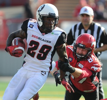 Chevron Walker from the Ottawa Redblacks  gets chased down by Simon Carbonneau-Campeau from the Calgary Stampeders during CFL action in Calgary, Alta. on Saturday August 9, 2014. Stuart Dryden/Calgary Sun/QMI Agency