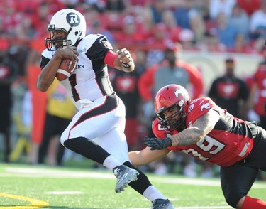 CAPTION CORRECTION---Corey Mace from the Calgary Stampeders (R) just misses QB Henry Burris  from the Ottawa Redblacks during CFL action in Calgary, Alta. on Saturday August 9, 2014. Stuart Dryden/Calgary Sun/QMI Agency