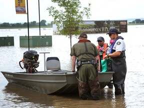 RCMP and Fish and Wildlife officers patrol the flooded Hampton Hills area in High River on July 4, 2013. (QMI Agency/File)