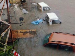 Stranded cars are seen in floodwater caused by Typhoon Halong in Kochi, western Japan in this photo taken by Kyodo August 10, 2014.    Mandatory credit REUTERS/Kyodo