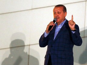 Turkey's Prime Minister Tayyip Erdogan gestures as he addresses to supporters during the celebrations of his election victory in front of the party headquarters in Ankara August 10, 2014. REUTERS/Umit Bektas