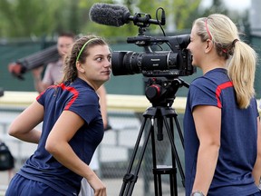 Cari Roccaro (left) and a teammate goof around with the team's video camera following a Team United States U-20 Women's National Team practice at Mill Woods Park, in Edmonton Alta., on Monday Aug. 4, 2014. David Bloom/Edmonton Sun/ QMI Agency