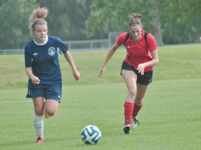 Heidi Robinson of the Portage Blaze, right, chases down an opponent during Portage's 2-0 win over Hanover Aug. 10. (Kevin Hirschfield/The Graphic)